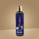 Lorena Organics coconut hair oil bottle on a beige background