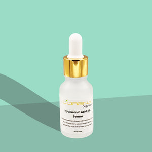 Skincare serum bottle with dropper on a green background