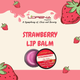 Lorena Organics Strawberry Lip Balm packaging with strawberry illustrations on a pink background