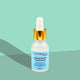 L'orena Organics  Niacinamide 10% + Zinc 1% Serum bottle with dropper on a green background